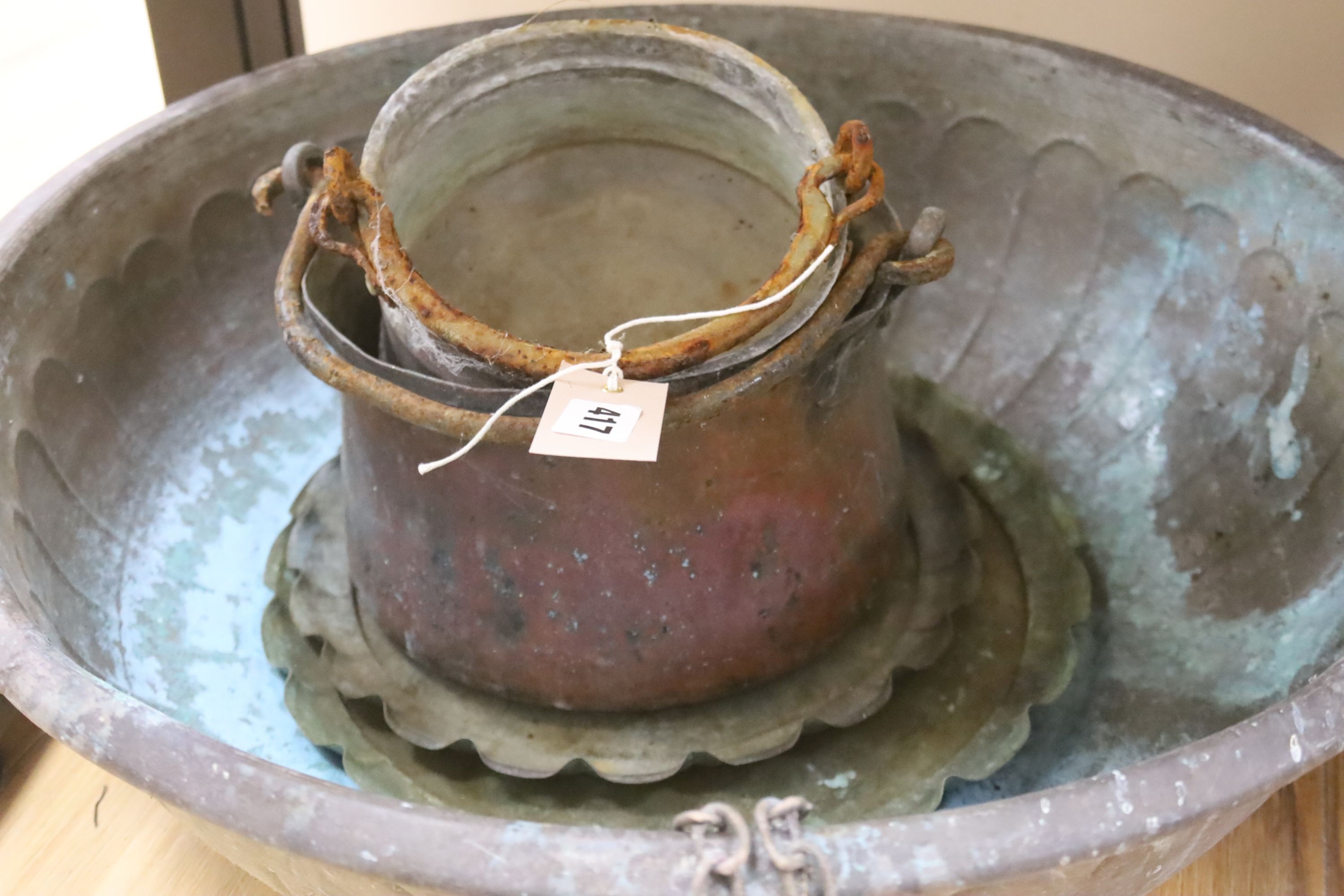 Two large copper bowls and related items, largest 54 cms diameter.